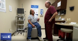 doctor talking to prostate cancer patient in medical room